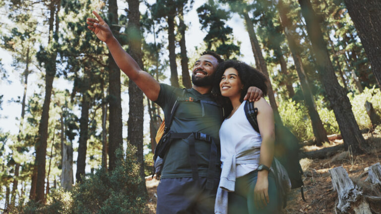 Happy couple hiking together in the woods after getting some advice